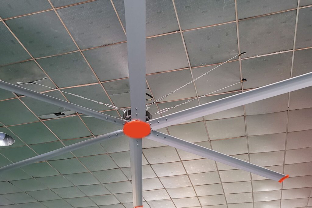 How do the costs of HVLS fans compare to traditional fans over the long term